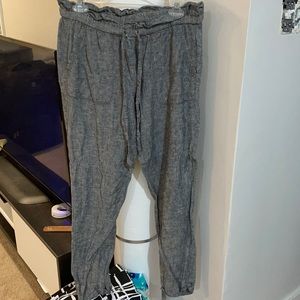 Gray linen pants with the trash bag effect at the top.